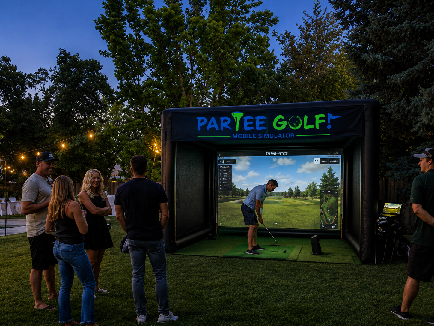 Guests gathered around the ParTee Golf mobile simulator in a backyard at dusk